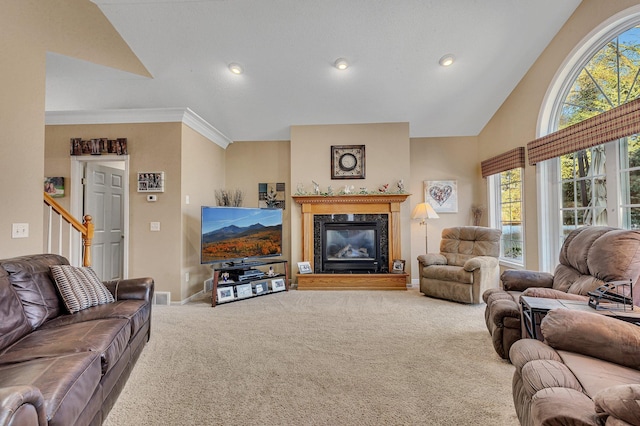 living room with carpet, ornamental molding, a fireplace, and vaulted ceiling