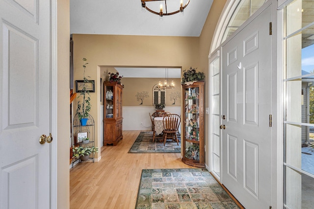 foyer entrance with a chandelier and light hardwood / wood-style floors