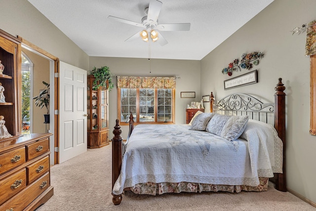 carpeted bedroom featuring ceiling fan and a textured ceiling