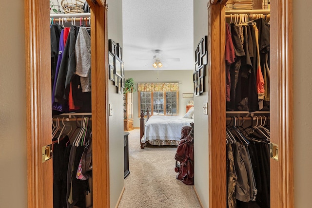 carpeted bedroom with a textured ceiling and ceiling fan