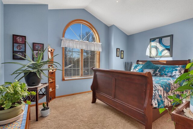 bedroom with carpet and vaulted ceiling