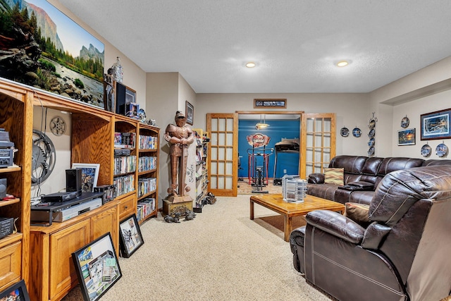 living room featuring carpet flooring, french doors, and a textured ceiling