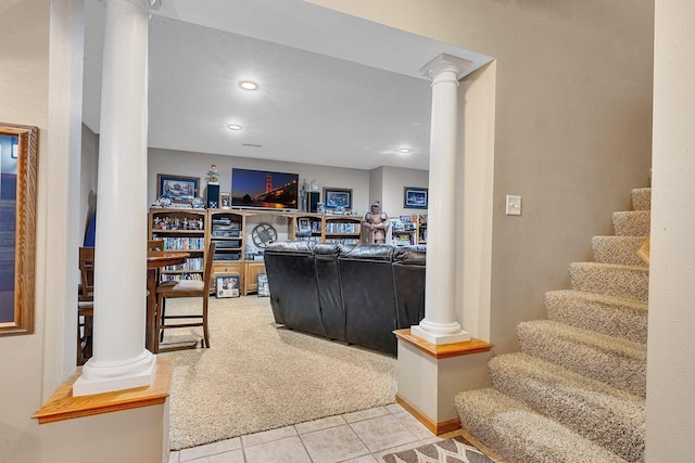 living room with decorative columns and light tile patterned flooring