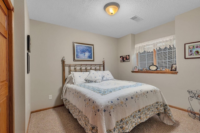 bedroom with carpet flooring and a textured ceiling