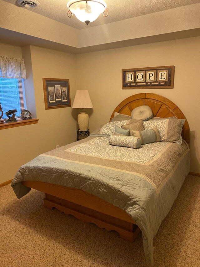 carpeted bedroom featuring a textured ceiling and billiards