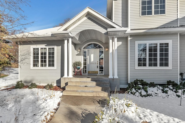 view of snow covered property entrance