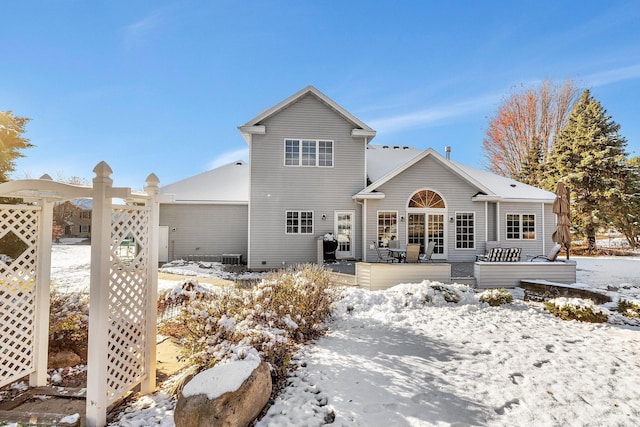 view of snow covered rear of property