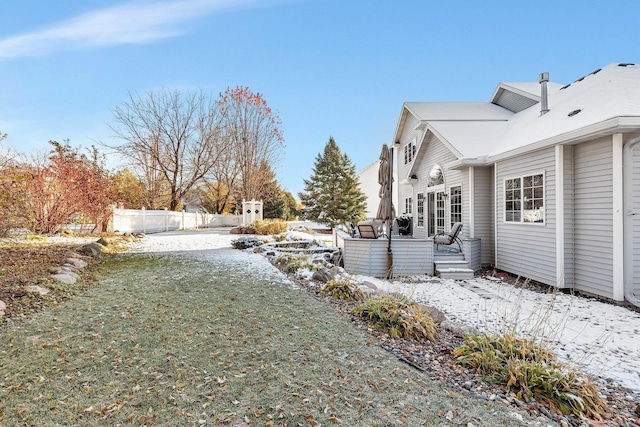 yard layered in snow featuring a wooden deck