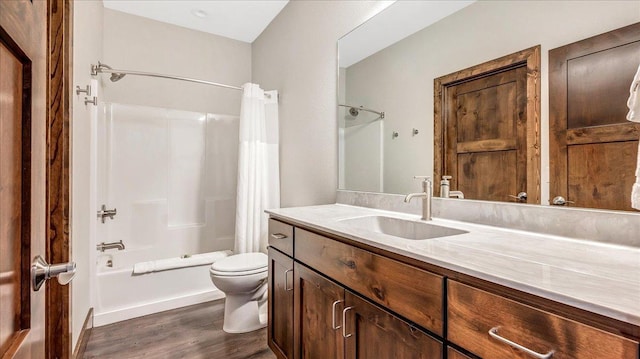 full bathroom with toilet, shower / tub combo, wood finished floors, and vanity