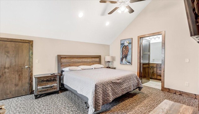 bedroom with light carpet, baseboards, ensuite bath, ceiling fan, and vaulted ceiling