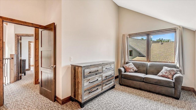 interior space featuring high vaulted ceiling, light carpet, and baseboards