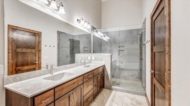 bathroom featuring double vanity, a sink, and a shower stall