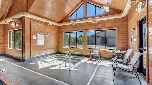 interior space featuring vaulted ceiling, wood ceiling, and a jacuzzi