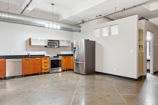 kitchen featuring a high ceiling, pendant lighting, and appliances with stainless steel finishes