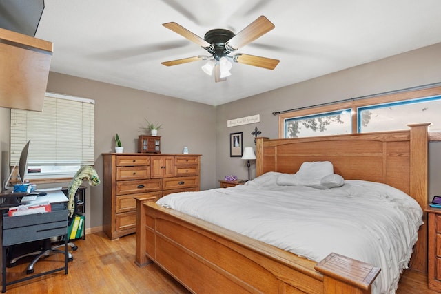 bedroom with light hardwood / wood-style flooring, multiple windows, and ceiling fan