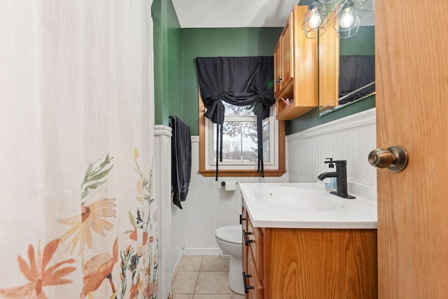 bathroom featuring vanity, toilet, and tile patterned flooring