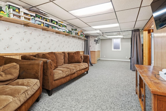 carpeted living room with a drop ceiling