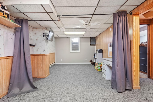 basement with carpet and wood walls