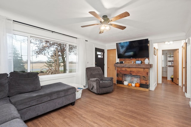 living room featuring ceiling fan and hardwood / wood-style floors