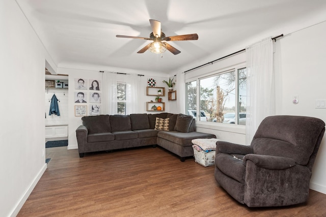 living room with dark wood-type flooring, built in features, and ceiling fan