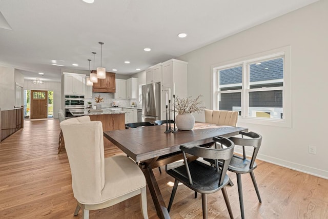 dining space with light hardwood / wood-style flooring