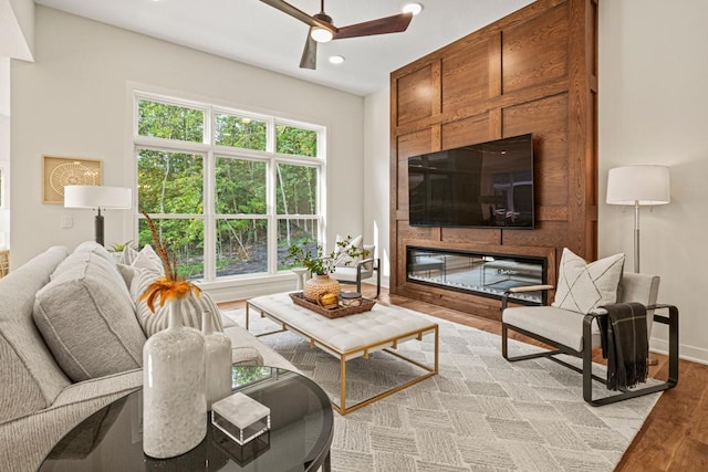 living room with light hardwood / wood-style flooring and ceiling fan