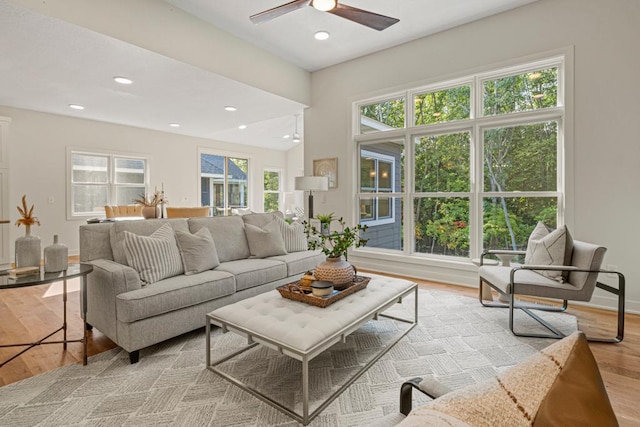 living room with light hardwood / wood-style floors and ceiling fan