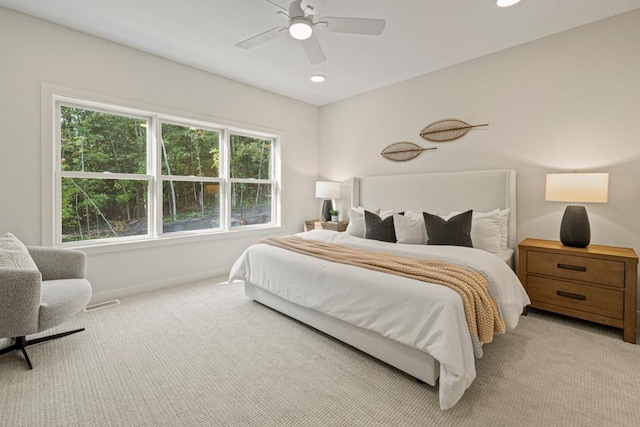 bedroom with ceiling fan and light carpet