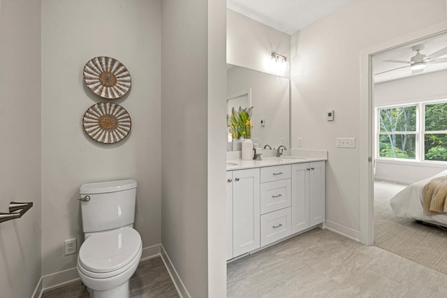 bathroom with ceiling fan, vanity, and toilet