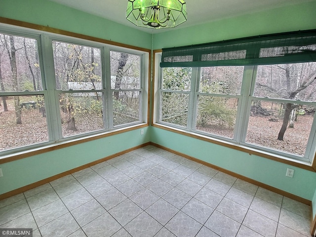 unfurnished sunroom with a notable chandelier