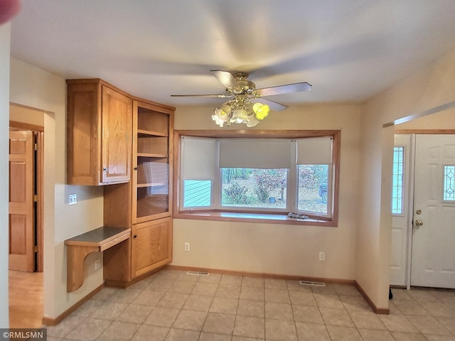 kitchen with ceiling fan and light tile patterned flooring