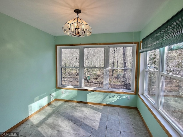 unfurnished sunroom featuring a wealth of natural light and an inviting chandelier