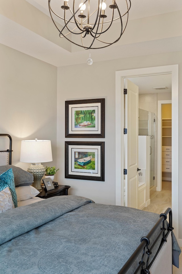 bedroom featuring a closet, a spacious closet, and a notable chandelier