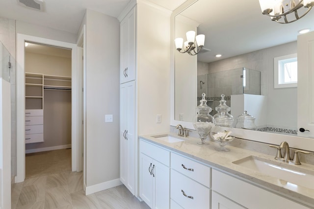 bathroom with vanity and tiled shower