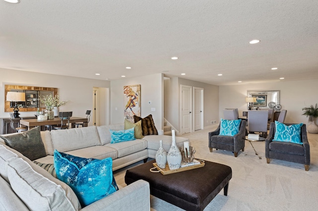 carpeted living room featuring a textured ceiling