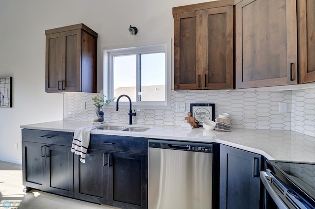 kitchen featuring dark brown cabinets, tasteful backsplash, stainless steel appliances, and a sink