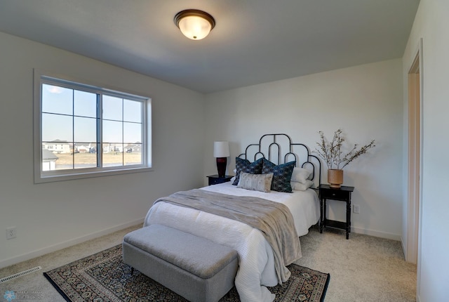 bedroom with carpet, visible vents, and baseboards