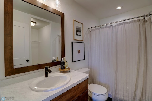 bathroom with toilet, recessed lighting, and vanity