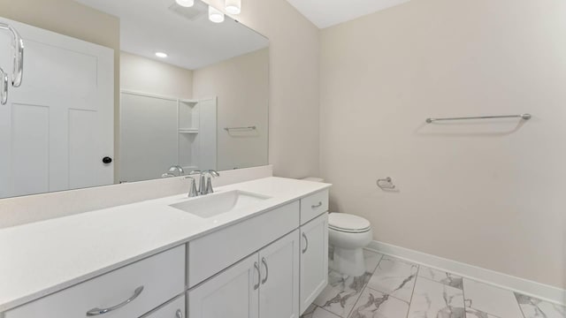 bathroom featuring toilet, a shower, and vanity