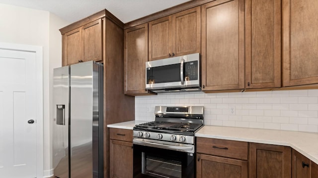 kitchen with stainless steel appliances and decorative backsplash