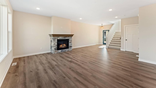 unfurnished living room featuring dark hardwood / wood-style flooring and a fireplace