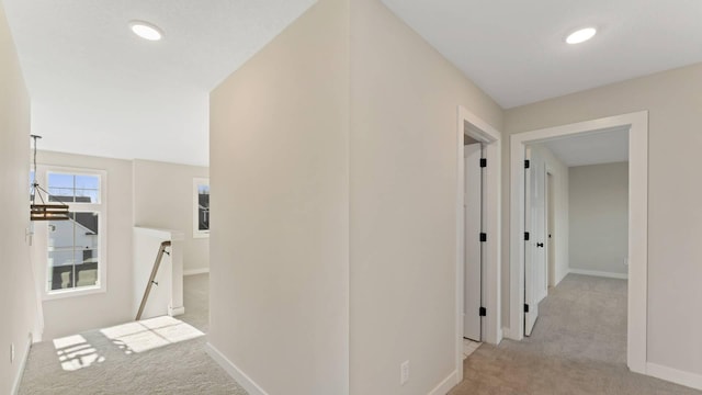 corridor with light colored carpet