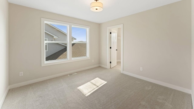 unfurnished room with light colored carpet