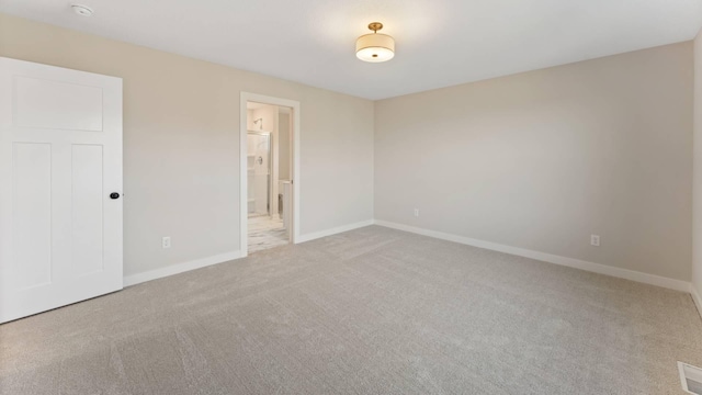 spare room with light colored carpet