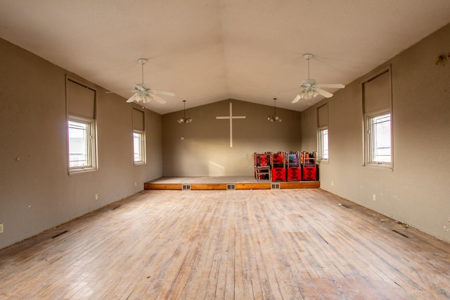 empty room with ceiling fan, a wealth of natural light, and light wood-type flooring