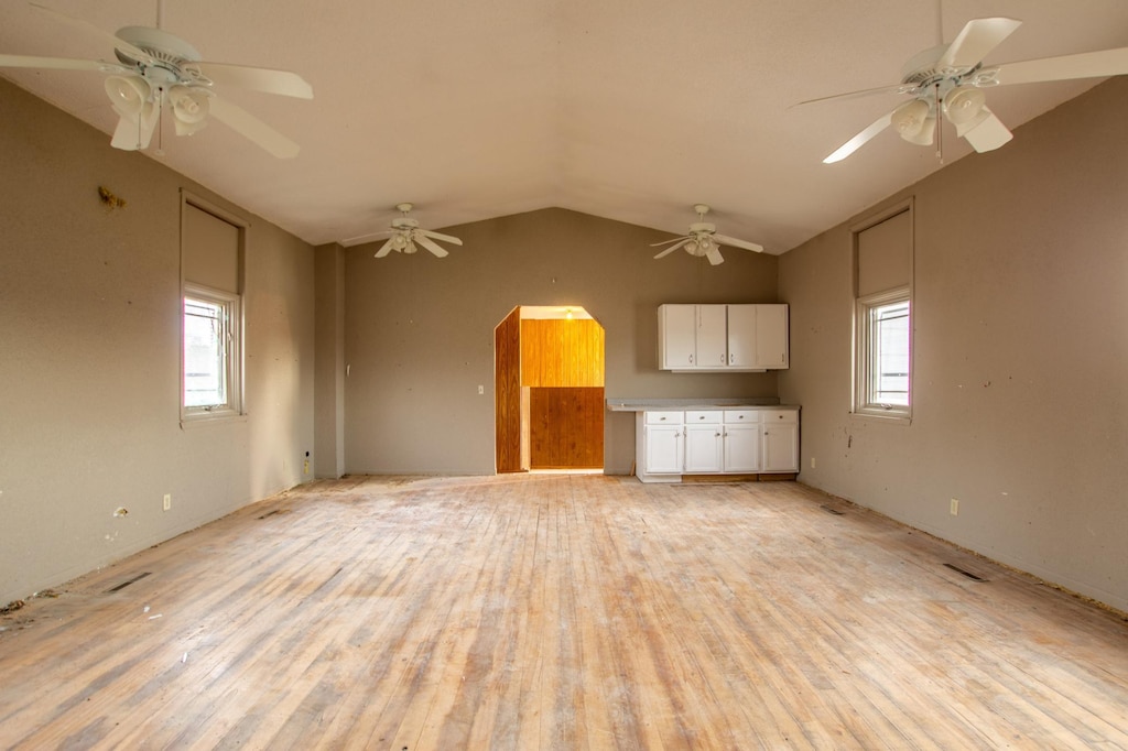 unfurnished living room with vaulted ceiling and light hardwood / wood-style flooring