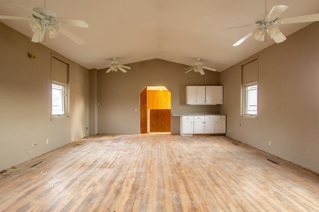 unfurnished living room with vaulted ceiling and light hardwood / wood-style flooring