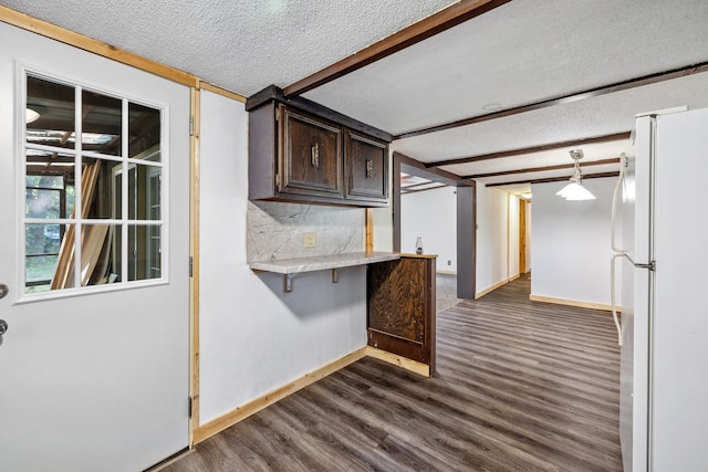 interior space featuring a textured ceiling and dark hardwood / wood-style floors