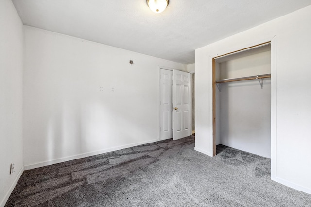 unfurnished bedroom with carpet floors and a closet