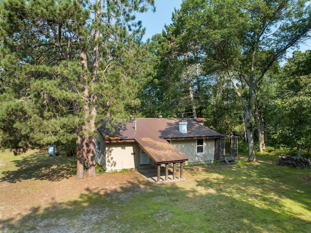 rear view of property with a lawn